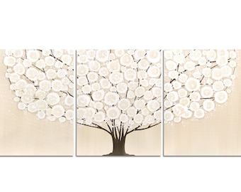 May include: A three-panel wall art set featuring a stylized tree with a dark brown trunk and branches. The canopy is composed of numerous circular white and cream-colored floral shapes against a solid, light beige background.