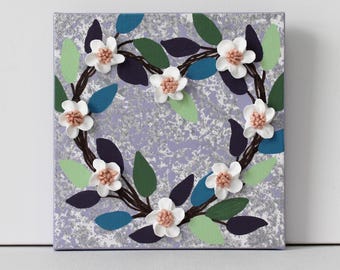 May include: A purple canvas painting with a heart-shaped wreath of white flowers with pink centers and green leaves. The background is a textured silver and purple.