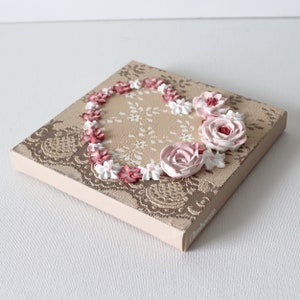 Flat angle view of little valentine heart painting with sculpted roses on a lacy textured canvas for gift for women