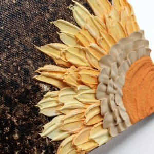 Close up of impasto texture on orange sunflower painting on a little canvas for a miniature art collection