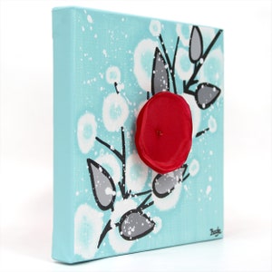 Side view of painting on mini canvas with 3d flower in red, black, and aqua