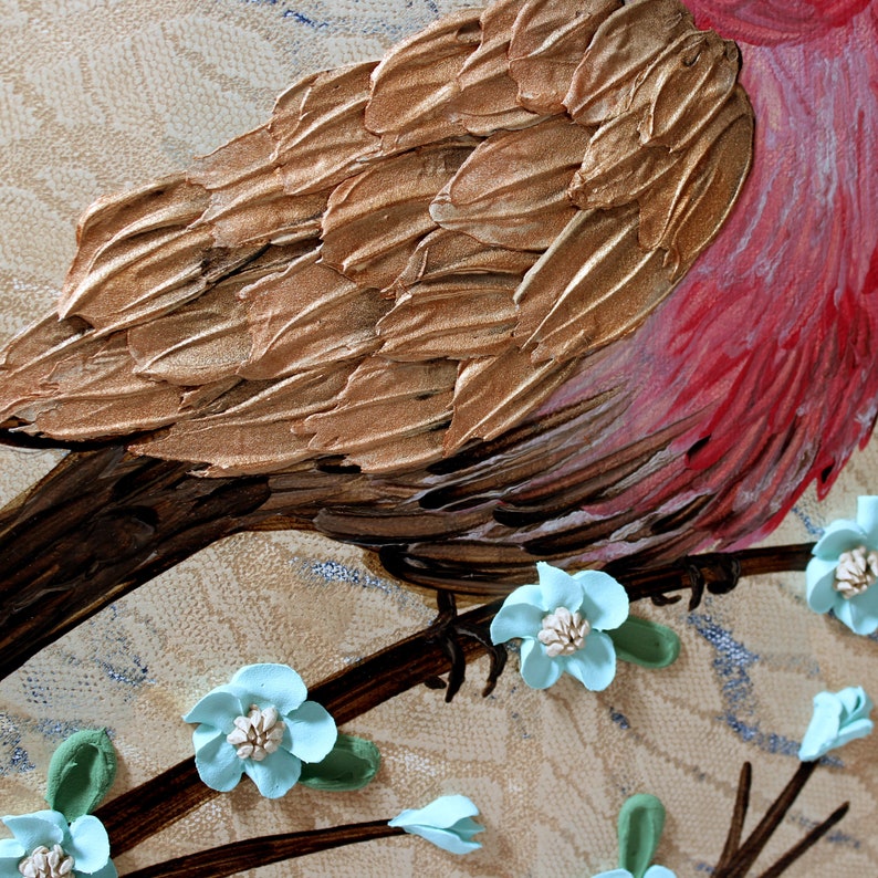 Close up of impasto textured copper feathers on painting of red finch bird with a robins egg blue flowering branch for farmhouse wall art