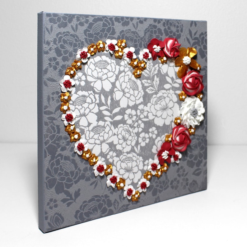 Side view of painting of heart art in red and gold with sculpted rose floral artwork on small canvas
