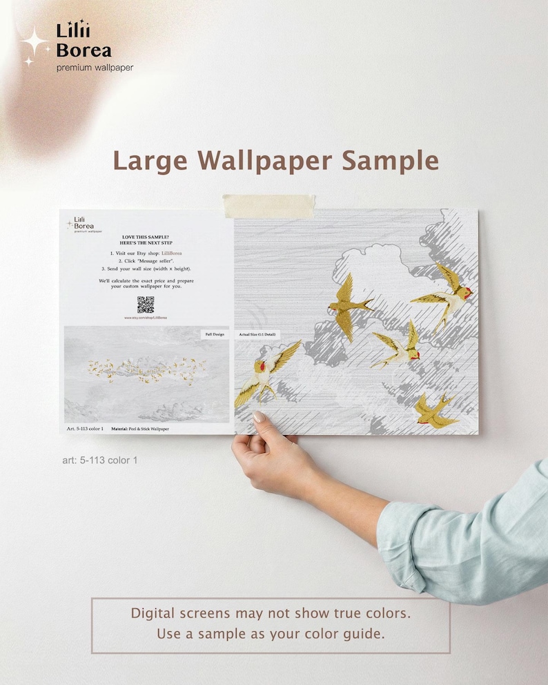 May include: A large wallpaper sample featuring a design of gold birds in flight against a gray and white background. The sample is held up, showcasing the design and the text "Large Wallpaper Sample". The brand name "Lilii Borea" is visible.