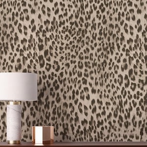 May include: Leopard print wallpaper in neutral tones with dark brown spots. The repeating pattern creates a textured animal print design. Suitable for interior design projects, the wallpaper's pattern is reminiscent of a wild animal.