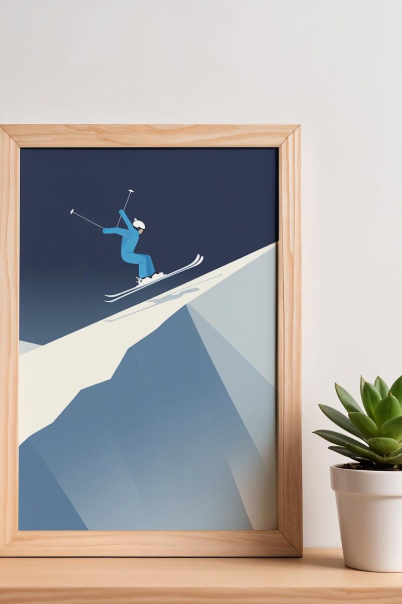 May include: A framed print featuring a skier in a blue outfit, skiing down a snow-covered mountain. The artwork has a minimalist style with a dark blue sky background and a light wood frame. A succulent plant in a white pot is in the foreground.