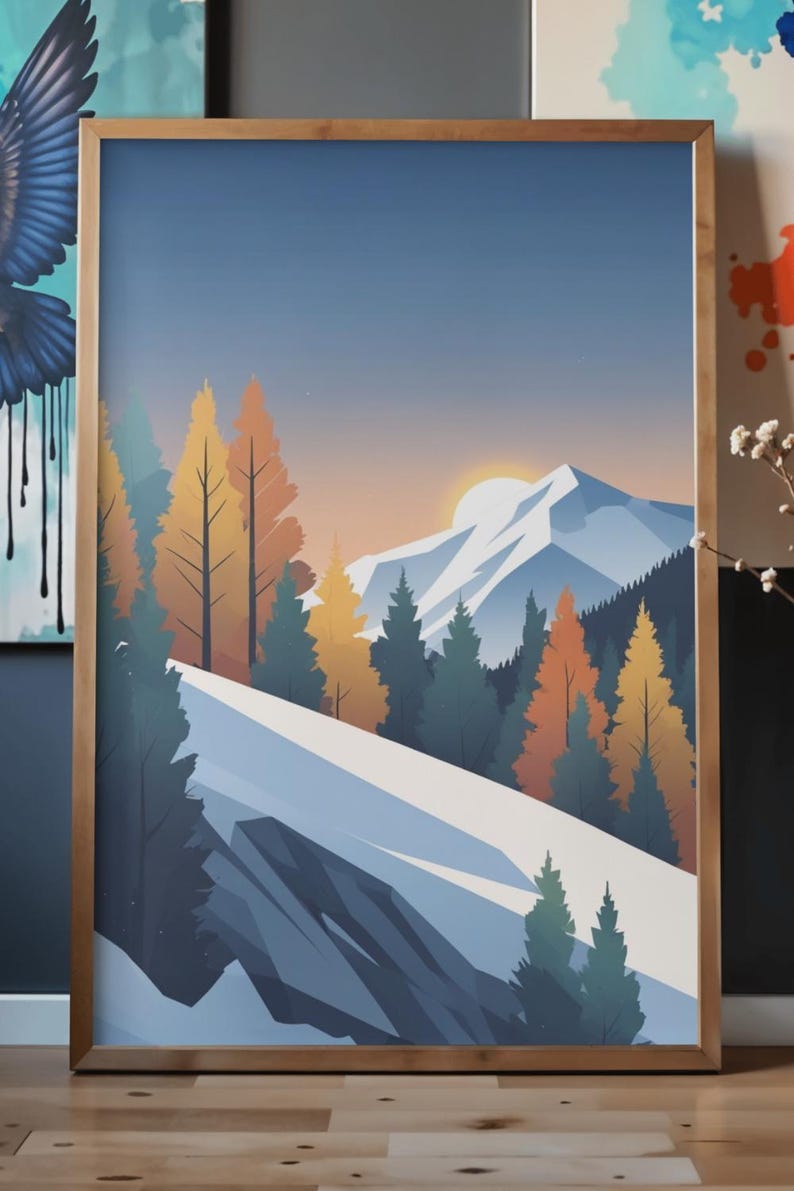 May include: A framed art print featuring a stylized mountain landscape. The artwork depicts a snow-covered mountain range, evergreen and autumn-colored trees, and a setting sun against a blue sky. The frame is made of wood.