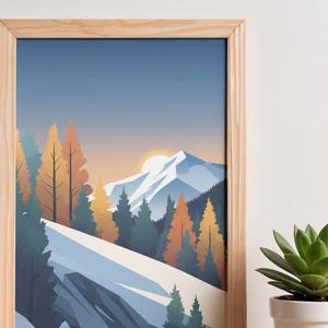 May include: A framed art print featuring a stylized mountain landscape. The artwork depicts snow-covered mountains, evergreen and autumn-colored trees, and a setting sun. The frame is made of light-colored wood.