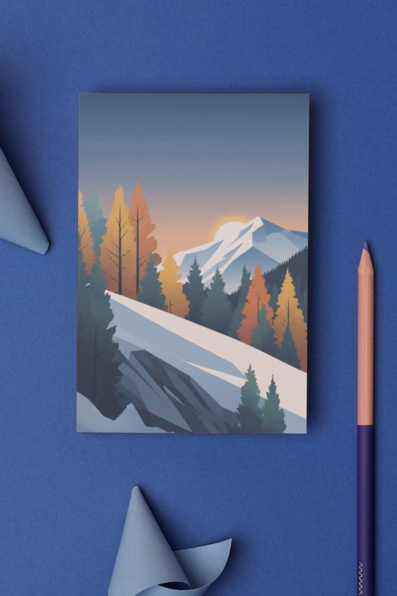 May include: A rectangular art print featuring a mountain landscape with snow-covered peaks, evergreen trees, and orange and yellow autumn trees. The artwork is set against a gradient sky with a setting sun. A blue background surrounds the print.