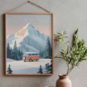 May include: A framed print featuring a stylized mountain landscape with an orange camper van. The artwork has a minimalist aesthetic with a color palette of blues, oranges, and whites. The print is hung by a natural rope.