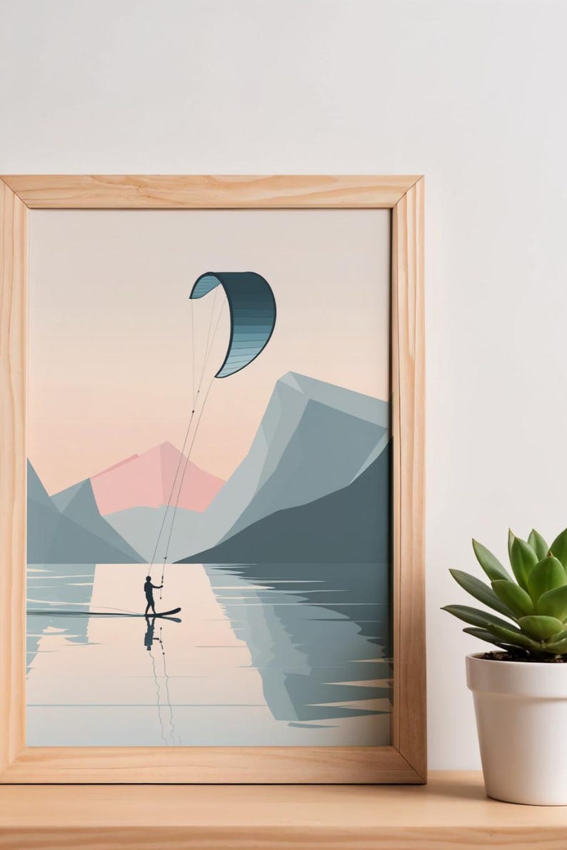 May include: A framed art print depicts a watersport scene. A person on a board is kiteboarding on a lake, with a blue and white kite overhead. Mountains in shades of blue and pink form the backdrop. The artwork is in a wooden frame.
