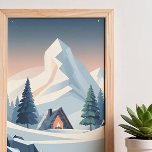 May include: A framed print showing a winter scene with a snow-covered cabin, fir trees, and a large mountain. The cabin has a lit fireplace. The colour scheme includes blues, whites, and a warm orange glow from the fire.