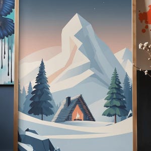 May include: A framed print depicting a winter scene with a snow-covered cabin and a lit fireplace, set against snow-covered mountains and evergreen trees. The artwork has a minimalist style with a colour palette of blues, whites, and warm orange.
