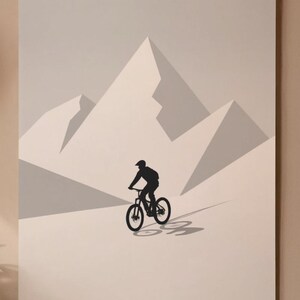 May include: A minimalist art print featuring a black silhouette of a mountain biker descending a slope. The artwork showcases a rider on a bicycle against a backdrop of stylized, light gray mountain peaks. The print is mounted and ready to hang.