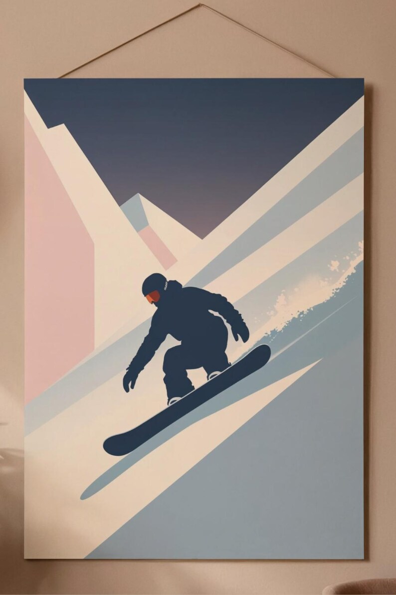 May include: A framed art print featuring a snowboarder silhouetted against a mountain landscape. The artwork uses a palette of blues, pinks, and whites to depict the snowy slopes and a dark blue figure carving down the mountain.