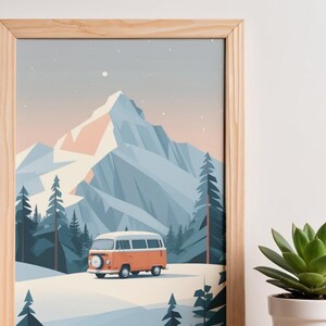 May include: A framed print featuring a stylized mountain landscape with a vintage orange and white camper van. The artwork depicts a snowy scene with pine trees and a large mountain range under a light blue sky. The frame is made of light-colored wood.