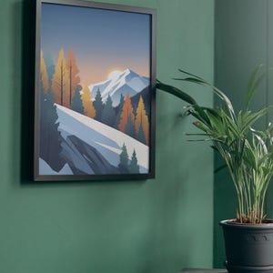 May include: Framed art print featuring a mountain landscape with a sunset. The artwork depicts a snow-covered mountain range, evergreen trees, and colorful autumn trees. The print is in a black frame and hangs on a green wall.