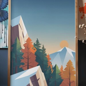 May include: A framed art print featuring a stylized mountain landscape. The artwork depicts snow-capped mountains, evergreen and orange trees, and a setting sun against a blue sky. The print is encased in a wooden frame.