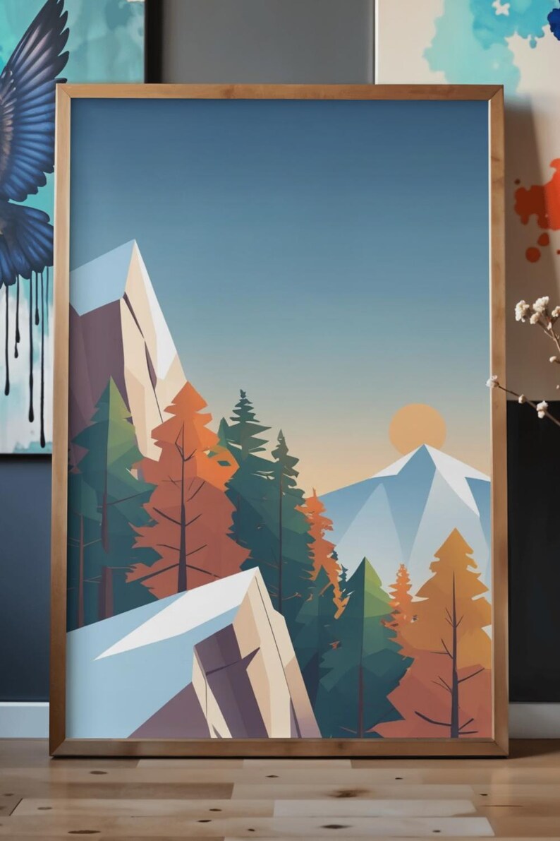 May include: A framed art print featuring a stylized mountain landscape. The artwork depicts snow-capped mountains, evergreen and orange trees, and a setting sun against a blue sky. The print is encased in a wooden frame.
