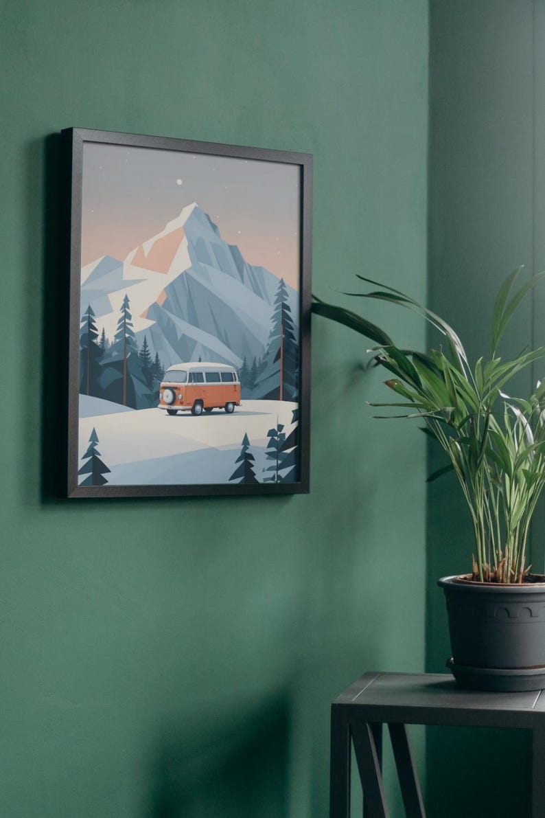 May include: Framed art print featuring a stylized illustration of a mountain landscape with an orange and white camper van. The artwork has a minimalist design with a color palette of blues, oranges, and whites. The print is in a black frame.