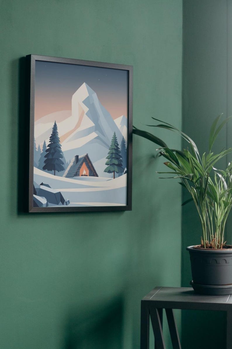 May include: Framed art print showing a mountain landscape with a cabin and evergreen trees. The artwork features a snow-covered scene with a mountain range in the background. The cabin has a warm glow from the fire. The frame is black.
