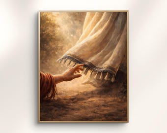 May include: A framed art print depicts a hand reaching towards a flowing white garment with a blue border and tassels. The artwork has a warm, golden color palette, suggesting a spiritual or religious theme. The style is painterly.