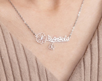 May include: Silver necklace with a delicate flower design and the name "Angela" written in cursive.