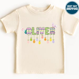 a t - shirt with the word love spelled in colorful letters