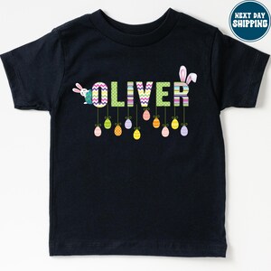 a black t - shirt with the word oliver printed on it