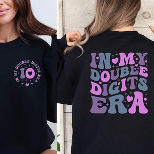 a woman wearing a t - shirt that says in my double digits era