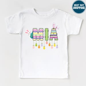 a white t - shirt with the word mom printed on it