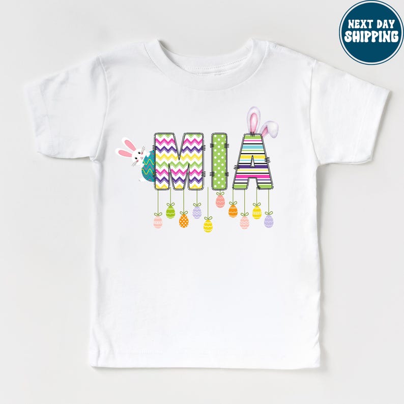 a white t - shirt with the word mom printed on it
