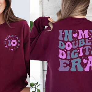 a woman wearing a sweatshirt that says, in my double digits era