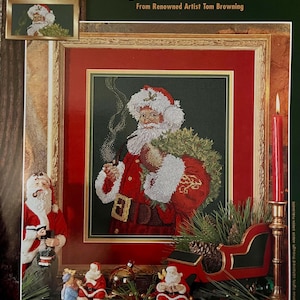 Könnte beinhalten: Ein gerahmtes Kreuzstichbild von Santa Claus, der eine Pfeife raucht, einen Kranz hält und einen roten Anzug trägt. Das Bild trägt den Titel "Spirit of Santa" und stammt von dem Künstler Tom Browning. Die Rahmengröße beträgt 40,6 cm x 45,7 cm.