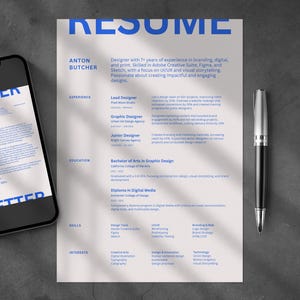May include: A resume with the word "RESUME" in large blue letters at the top. The resume includes the name "ANTON BUTCHER" and details about experience, education, and skills. A smartphone with a cover letter on the screen and a pen are next to the resume.