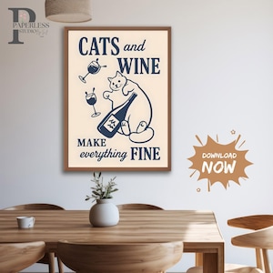 May include: A framed print with the words "CATS and WINE MAKE everything FINE" in navy blue. The image features a cat holding a wine bottle and two wine glasses. The print has a cream background and a brown frame.