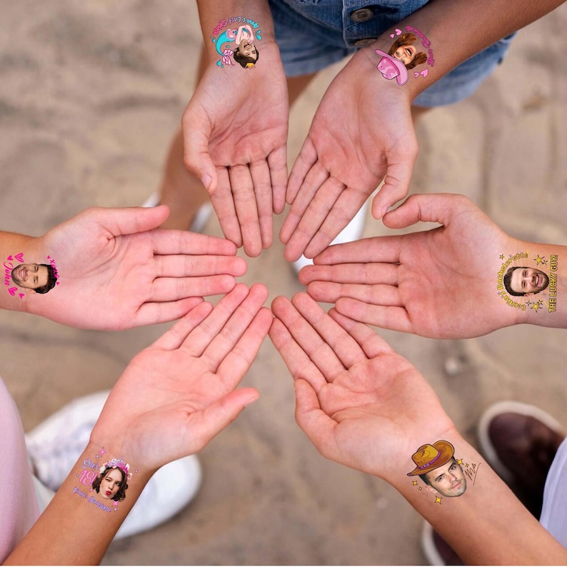 May include: A collection of temporary tattoos applied to wrists, featuring various colorful designs including cartoon characters, a pink cowboy hat, a brown cowboy hat, and custom portrait faces with text like "The Lucky Guy" and "She said yes".