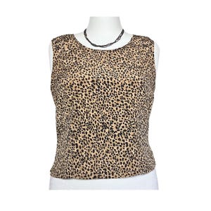 May include: A sleeveless top with a leopard print pattern in shades of brown and black.