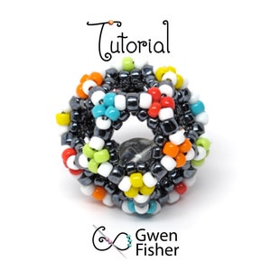May include: A colorful beaded sphere with a hole in the center. The beads are in various colors, including red, orange, yellow, green, blue, and white. The sphere is made of small beads and is about the size of a golf ball. The sphere is on a white background. The text "Tutorial" is above the sphere.
