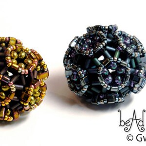 May include: Three beaded spheres, each with a different color scheme. The first sphere is brown, gold, and green. The second sphere is blue, purple, and silver. The third sphere is black, purple, and gold. The spheres are all about 1 inch in diameter.