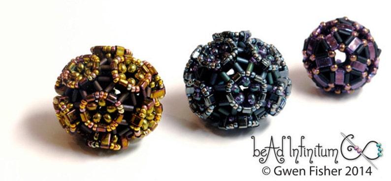 May include: Three beaded spheres, each with a different color scheme. The first sphere is brown, gold, and green. The second sphere is blue, purple, and silver. The third sphere is black, purple, and gold. The spheres are all about 1 inch in diameter.