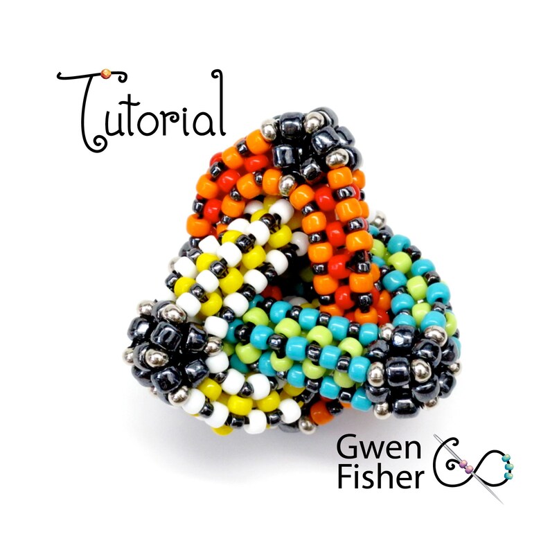 May include: A colorful beaded ring in a triangular shape. The ring features beads in black, silver, orange, yellow, white, green, and turquoise. The word "Tutorial" is written in cursive. The designer's name, Gwen Fisher, is also visible.