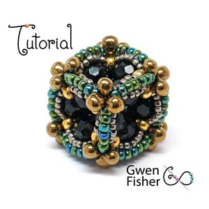 May include: A beaded cube with a geometric design. The cube is made with black, gold, green, and silver beads.