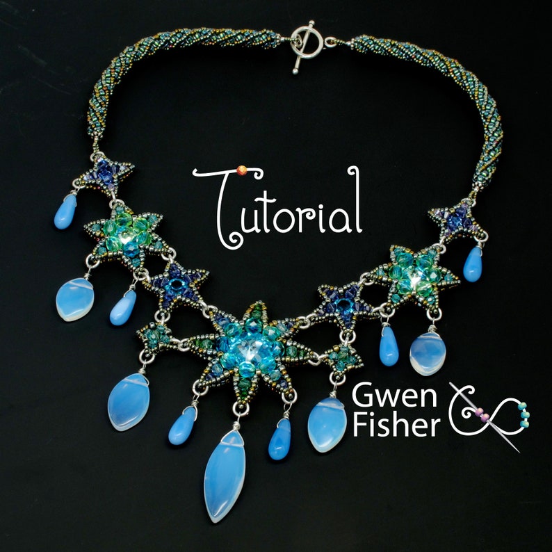 May include: A beaded necklace with a starburst design in shades of blue and green. The necklace features a central starburst with smaller starbursts on either side. The necklace is accented with teardrop-shaped beads in a light blue color. The necklace is labeled "Tutorial" and "Gwen Fisher".