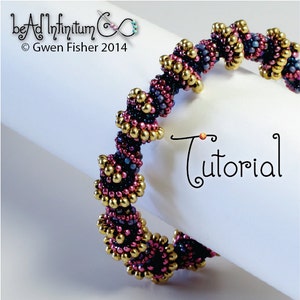 May include: A close-up of a beaded bracelet with a spiral design. The bracelet is made with gold, purple, and blue beads. The bracelet is on a white surface with the word "Tutorial" written in black.