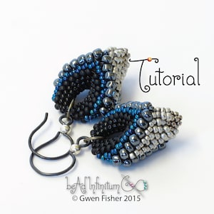 May include: A pair of silver, black, and blue beaded earrings with a teardrop shape. The earrings are made with seed beads and have a silver wire hook.