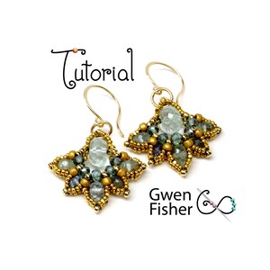 May include: A pair of gold earrings with a star-shaped design. The earrings are made with beads in shades of green, blue, and gold, and feature a larger, light blue gemstone in the center of each star.