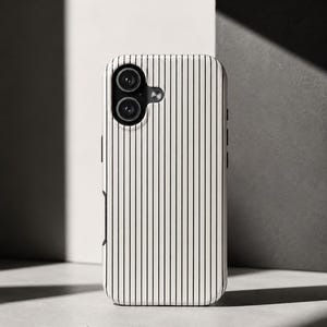 May include: A white and black striped phone case with a dual-lens camera cutout. The case has a vertical pinstripe design and is made of a smooth, glossy material. The phone case is designed to protect the phone from scratches and damage.