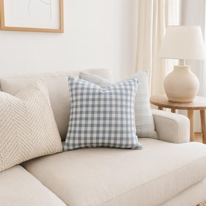 Minimalist blue white gingham pillow on a living room sofa