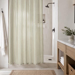 Cottagecore bathroom with natural sage green shower curtain